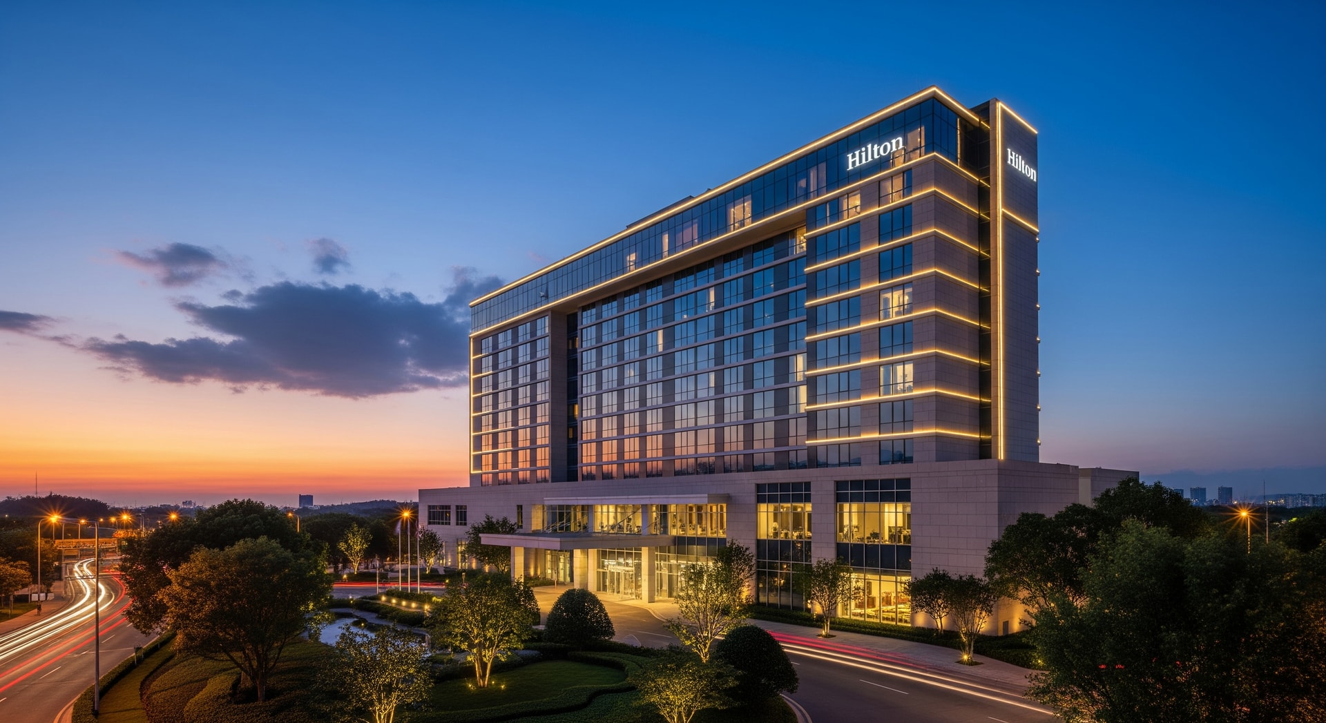 Exterior of a Hilton hotel at dusk, representing global hotel portfolio growth