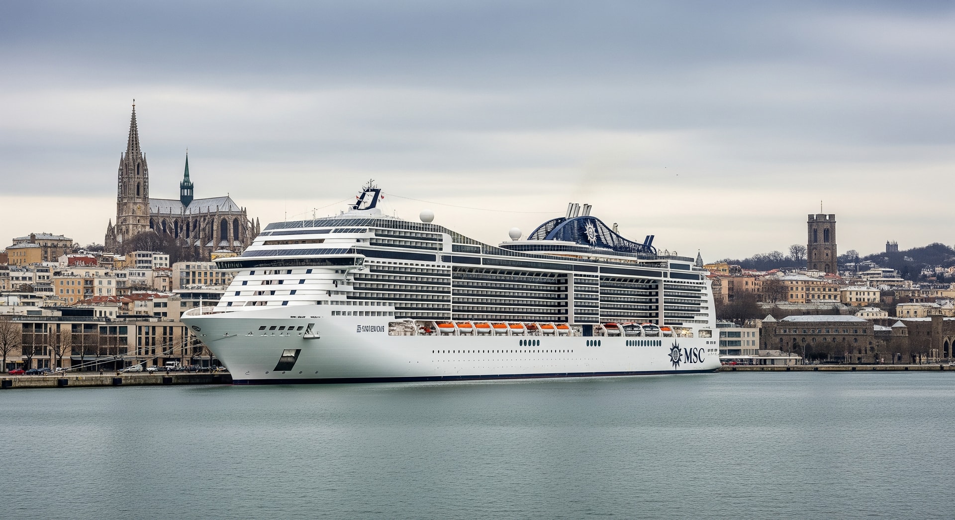 MSC cruise ship docked at a European port during winter with city skyline in the background