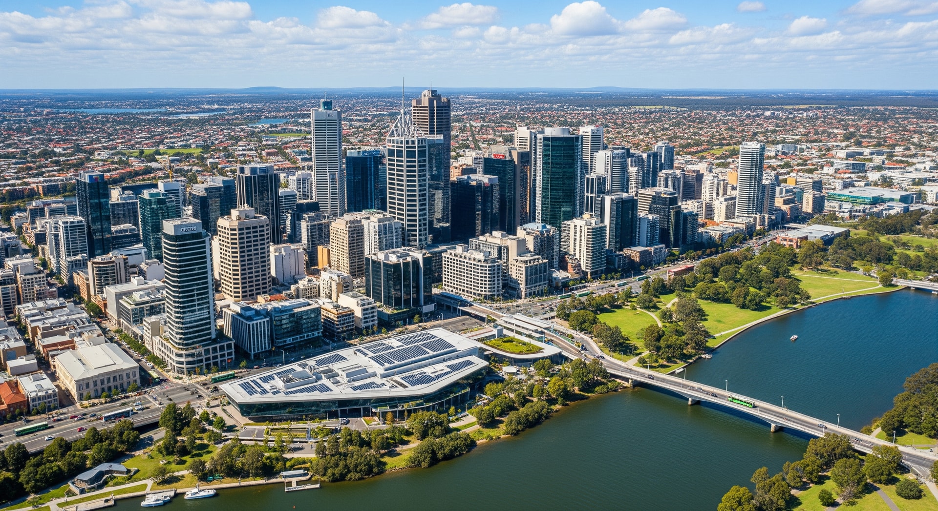 Aerial view of Australian city skyline with green parks and sustainable transport