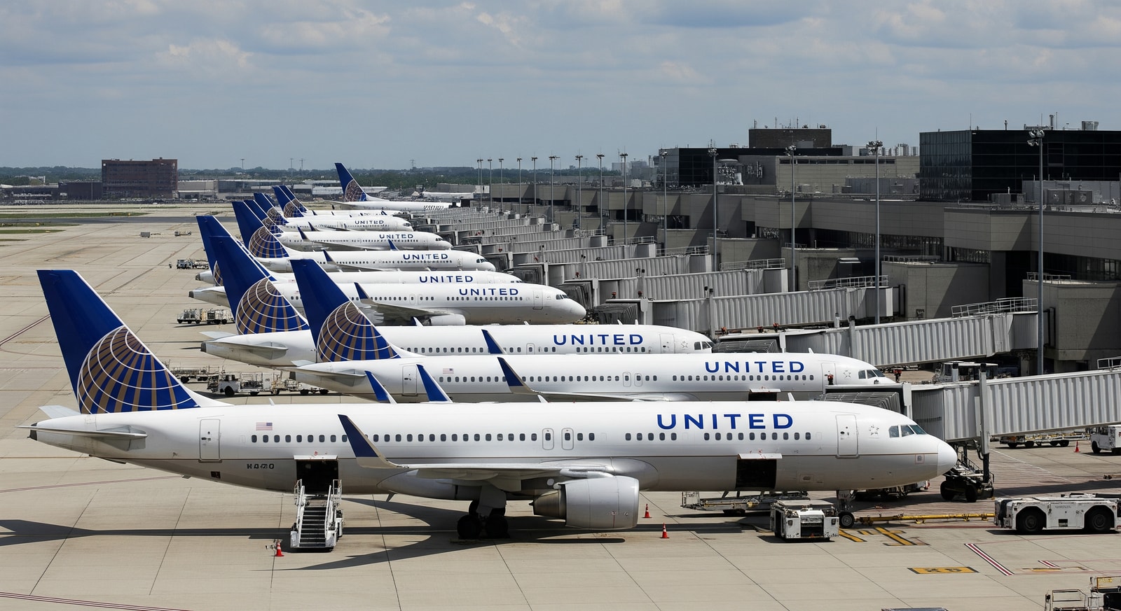 United Airlines jets at Chicago O'Hare apron with terminals in the background, illustrating increased flight operations